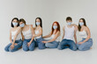 © Roman Shalenkin/Stocksy - Group portrait of diverse people in masks  in studio