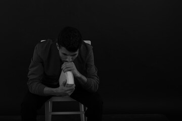 The man with a book sitting on the chair