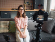 © ZHPH Production/Stocksy - Woman recording video at home