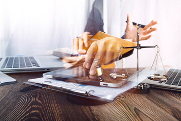 Business and lawyers discussing contract papers with brass scale on desk in office. Law, legal services, advice, justice and law concept picture with film grain effect