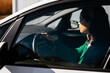 © BONNINSTUDIO/Stocksy - Young woman driving car on sunny day