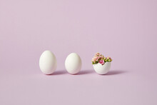 Easter Eggs With Blossoming Flowers On Purple Background