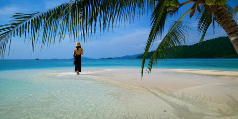 Poster - woman walking on white sand beach in the  andaman sea 