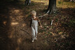 © Melissa Milis Photography/Stocksy - Blond child walking in the woods being frustrated