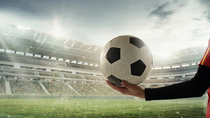 Female hands with soccer, football ball isolated over stadium before sport match on cloudy sky background. Collage. Concept of sport, competition