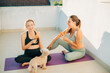 © Olga Moreira/Stocksy - Pregnant women talking and eating snack after yoga class