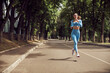 © Yaroslav Astakhov - Beautiful fit young woman jogger is running outdoors