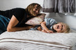 © Samantha Gehrmann/Stocksy - pregnant mother and daughter play on mattress