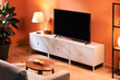 © Martí Sans/Stocksy - Interior of living room with TV set