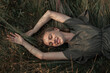 © Andrei Aleshyn/Stocksy - Portrait of a beautiful young smiling woman on the grass in the