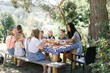 © Léa Jones/Stocksy - family enjoying a meal outdoors