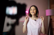 © Felix Chacon/Stocksy - young woman recording herself video at home studio