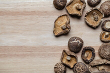 Many Dried Shiitake Mushrooms Were Placed On The Background Of Materials Made From Softwood.
