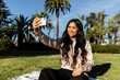 © McKinsey Jordan/Stocksy - Beautiful Woman Takes Selfie at Park