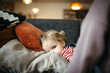 © Melissa Milis Photography/Stocksy - girl resting with her head on cushions