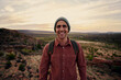 © StratfordProductions - Portrait of successful happy male hiker with backpack and cap looking at camera