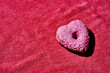 © Juan Moyano/Stocksy - pink heart-shaped donut on a pink fabric