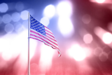 American flag waving with blurred light background