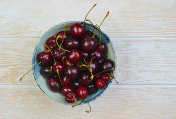 fresh and ripe cherry in a ceramic bowl, sweet summer berry