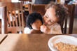 © Jennifer Bogle/Stocksy - Toddler shares cookie with doll