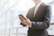© Attasit - business man using mobile smart phone, copy space.