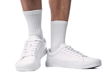 Closeup Of Male Feet And Shoes. Man Wearing White Trainers On White Background.