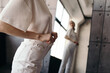 © Sergey Filimonov/Stocksy - Woman trying on jeans standing in front of mirror