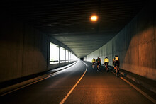 Cyclists Racing Through Tunnel