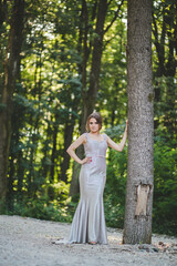 Canvas Print - Vertical shot of an elegant caucasian female in a white evening dress