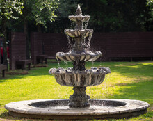 Stone Water Fountain In A Garden With Water Splashing