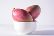 Fresh palmer mango fruit in bowl on white background, Tropical fruit	