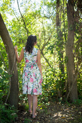 Sticker - Unrecognizable woman with a floral dress  posing in the forest