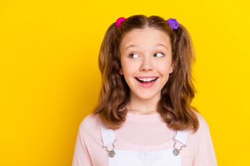 Poster - Photo portrait smiling amazed happy schoolgirl with tails looking copyspace isolated bright yellow color background