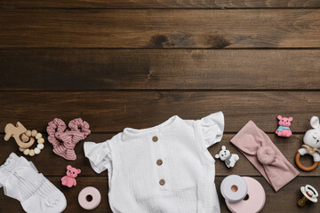 Wall Mural - Flat lay composition with baby clothes and accessories on wooden table. Space for text