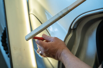 Process Of Paintless Dent Repair On Car Body. Technician s Hands With Puller Fixing Dent On Rear Car Fender. PDR Removal Course Training