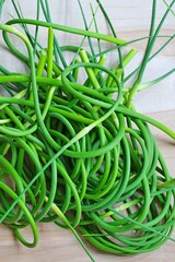 Wall Mural - Bunches of freshly picked green garlic scape stems