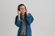 © Drobot Dean - Young brunette man smiling and listening to music with headphones
