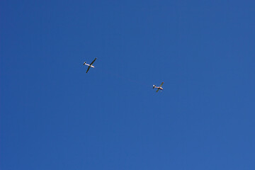 two light planes in the blue summer sky