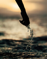 Canvas Print - Water dropping from a hand