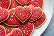 © Julie Rideout/Stocksy - Red Heart Shaped Valentine's Day Sugar Cookies