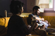 © Ana Luz Crespi/Stocksy - Parents getting ready to feed their baby at home