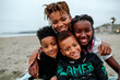 © Erin Brant/Stocksy - Happy Black siblings on beach blanket