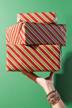 Woman's Hand Holding A Pile Of Presents