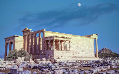 Athens Acropolis Greece, moon still on the morning sky over Erechtheion ancient temple and Caryatids