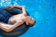 © Tytia Habing/Stocksy - Teen Boy on Innertube in a Pool