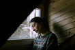 © Demetr White/Stocksy - portrait of a sad girl at the window