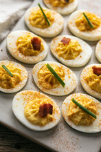 Tasty Deviled Eggs On Tray With Bacon And Chives