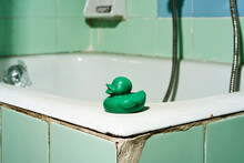 Green Rubber Duck On A Bathtub