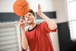 © zinkevych - Ginger man in a red sportswear throwing the ball to the basket