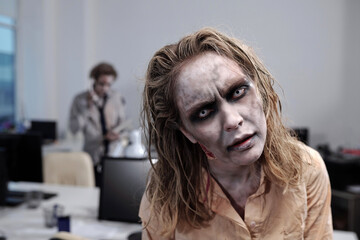 Wall Mural - Horror movie zombie standing in front of camera in open space office